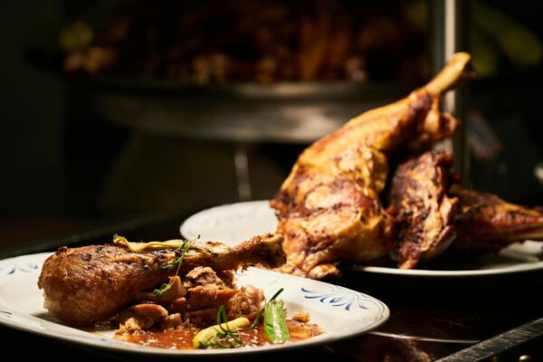 Delicious roast chicken legs garnished with herbs, perfect for a cozy dinner.